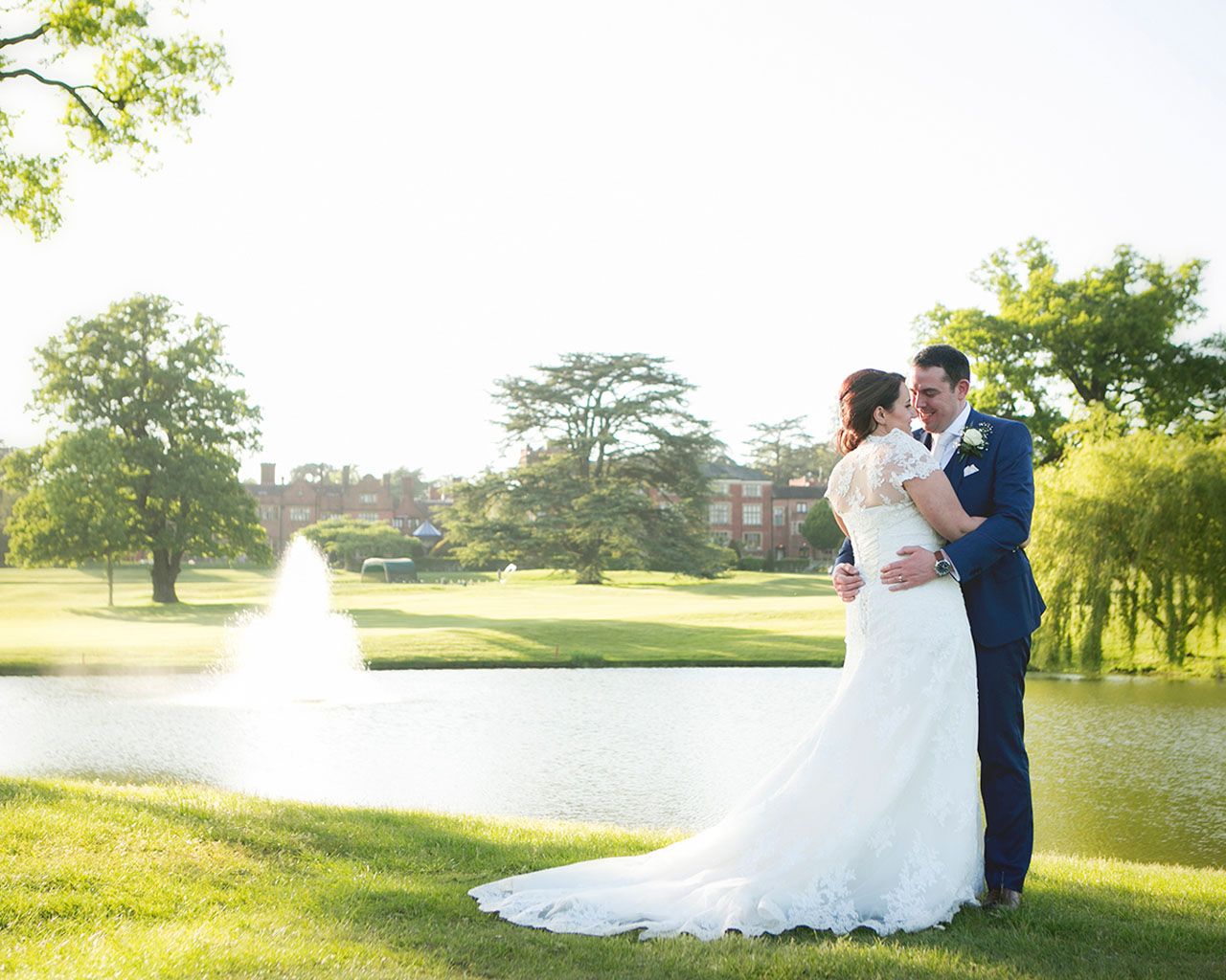 Anne Marie and Andrew in front of the lake at Hanbury Manor - Photography by Katrina Matthews Photography - Videography by Veiled Productions - Hanbury Manor Wedding Videographer