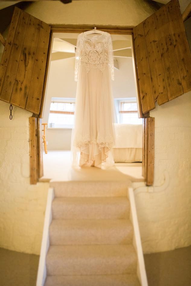 Why we love winter weddings - Hannah's wedding dress hanging proudly in the Oast House honeymoon suite at Bury Court
