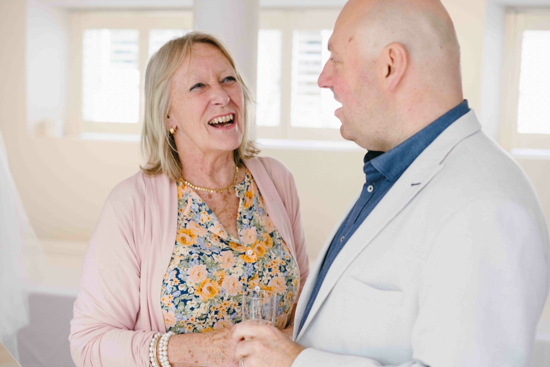 Adrian chatting and laughing with a wedding guest during the drinks reception. Photography by Des Dubber Photography. Videographer - Veiled Productions