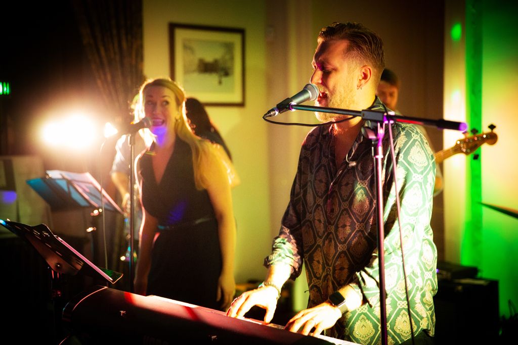Ubermeister band singing and playing the keyboard at Aimee and Simon's wedding at Clearwell Castle. Photo thanks to Mark Lord Photography.