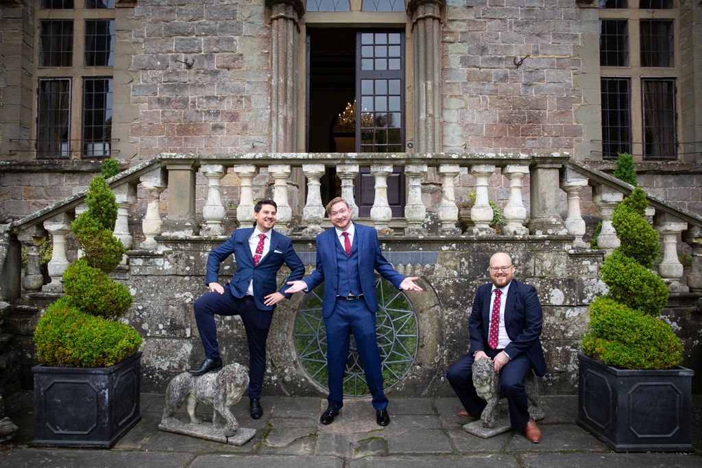 Simon and his groomsmen at the front of Clearwell Castle posing with the statues! Photo thanks to Mark Lord Photography.