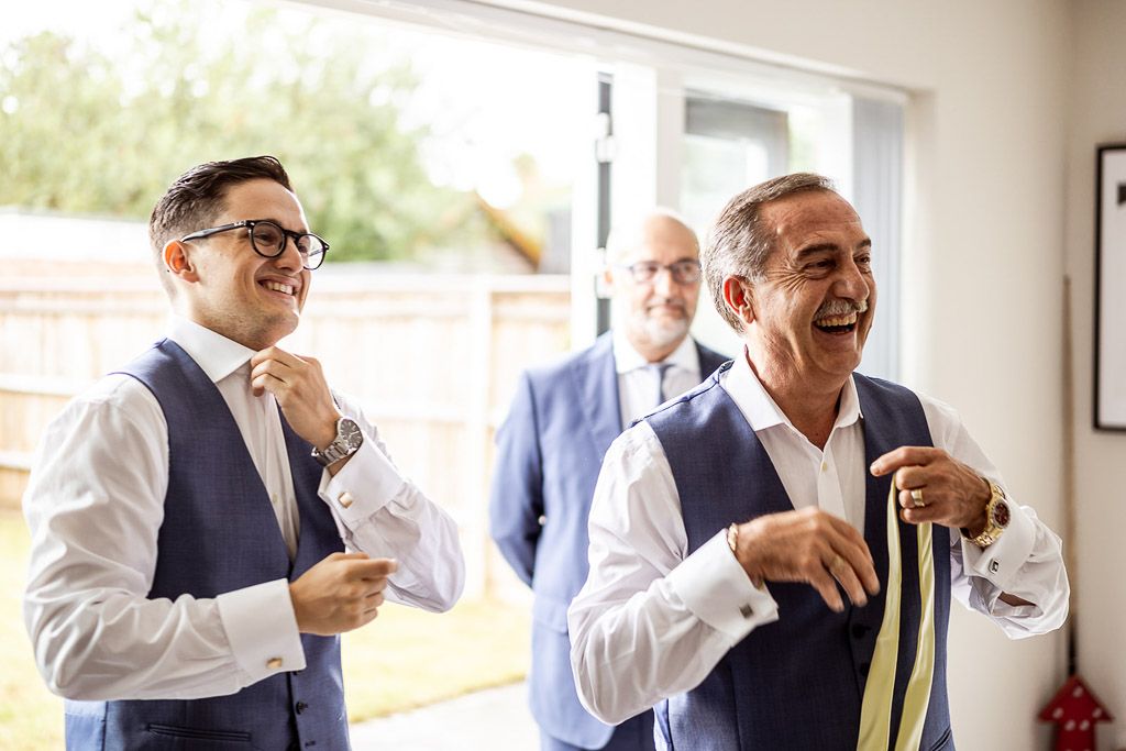 Mario and his family getting ready for the wedding at home. Wedding photo by Allister Freeman. Videography by Veiled Productions - unique wedding videographer Bury Court Barn