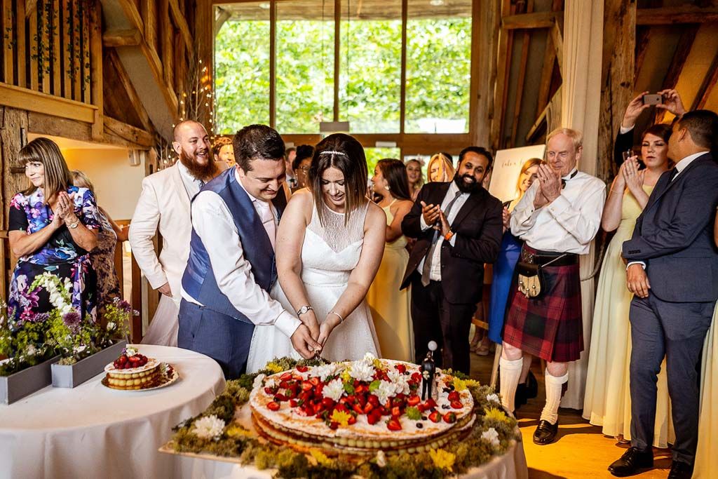 Amy and Mario cutting their Italian wedding cake. Wedding photo by Allister Freeman. Videography by Veiled Productions.