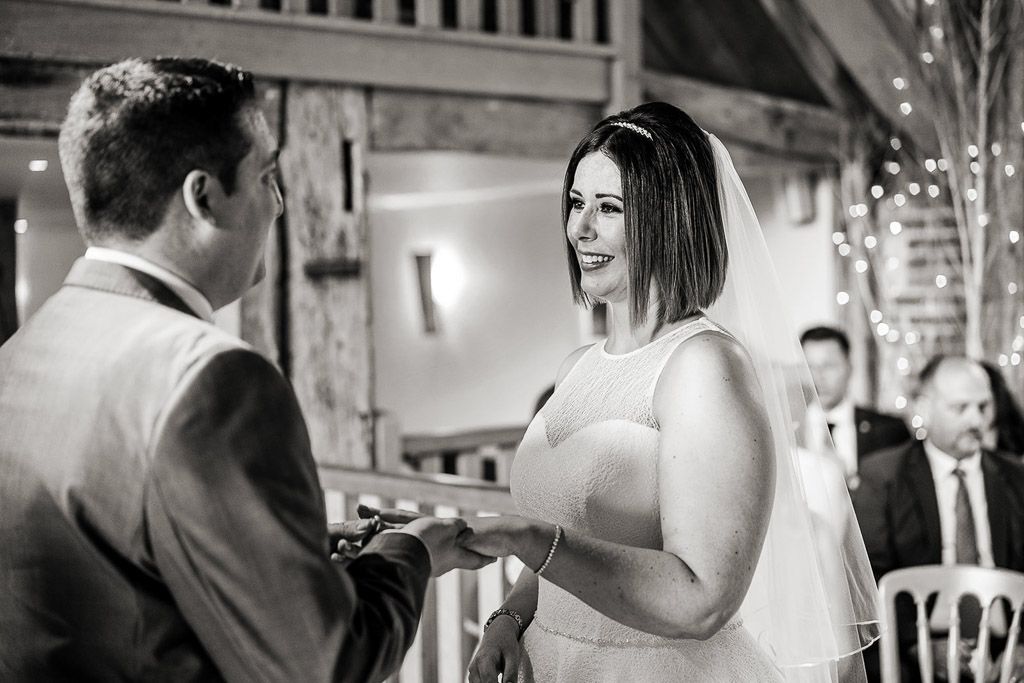 Amy and Mario exchange rings during their civil ceremony. Wedding photo by Allister Freeman. Videography by Veiled Productions - unique wedding videographer Bury Court Barn