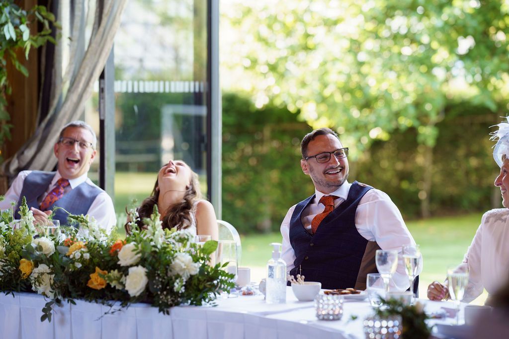 Laugh out loud moments - Bex and Dan laughing at the best man speech during their wedding reception at Redhouse Barn. Photo thanks to J Bidmead Photography.