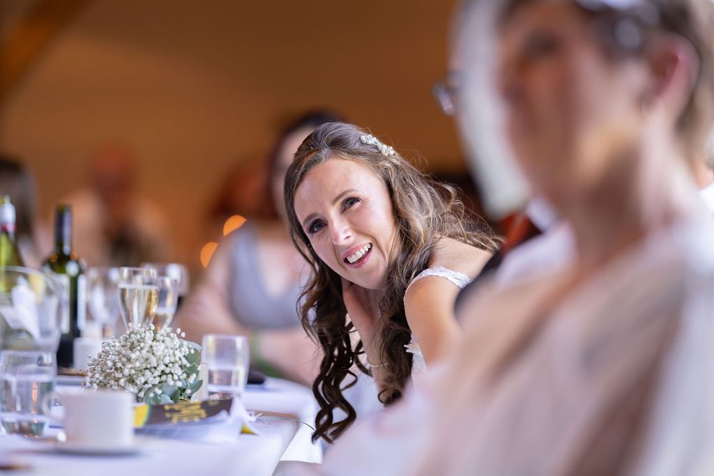 Bex looking emotional during the speeches at their wedding reception at Redhouse Barn. Photo courtesy of J Bidmead Photography.