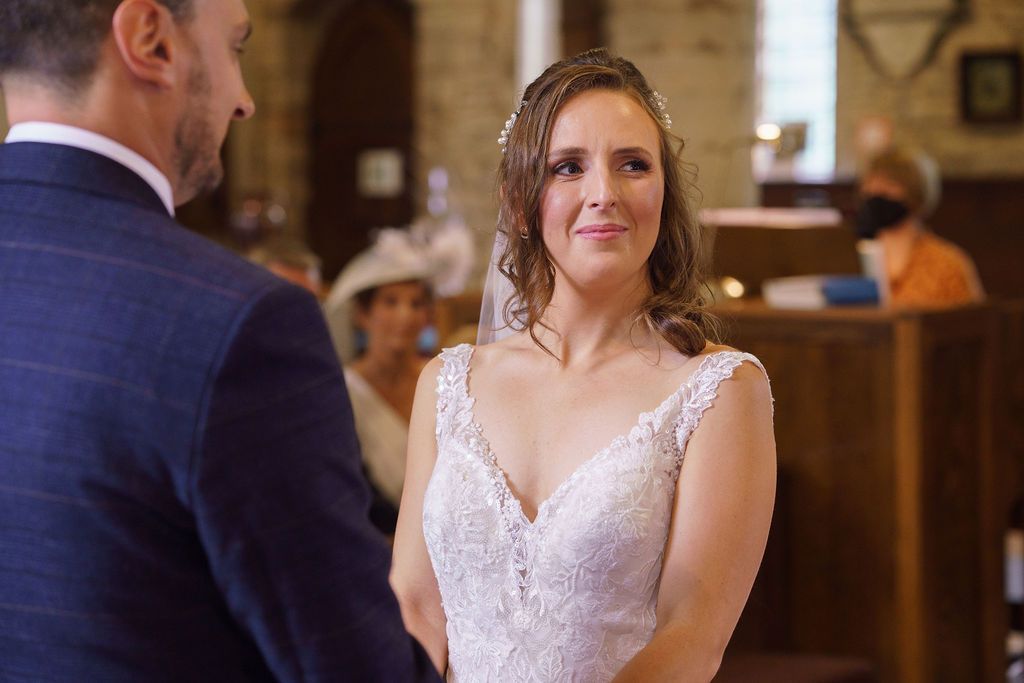 Bex and Dan at the alter saying their vows - photos thanks to J Bidmead Photography