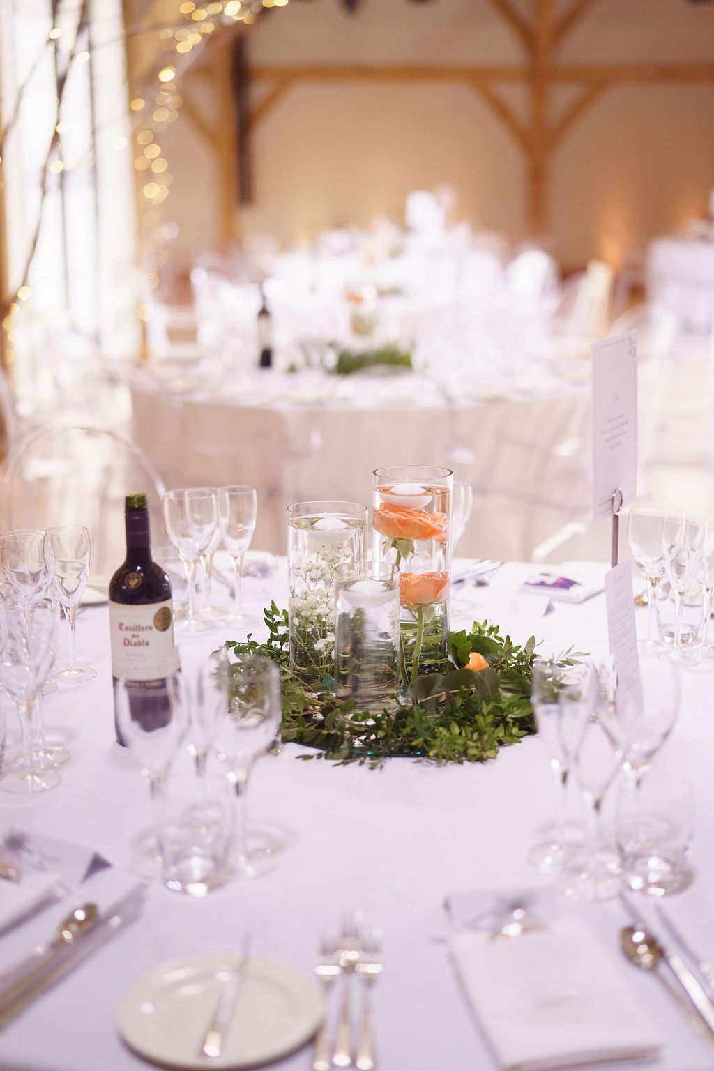 Beautiful table decorations and greenery centre pieces for Bex and Dan's wedding - photo thanks to J Bidmead Photography