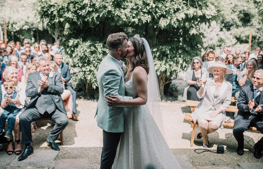 Erin and Vinnie just announced as husband and wife seal their marriage with a kiss - photography by The Kensington Photographer - Fun Videography by Veiled Productions