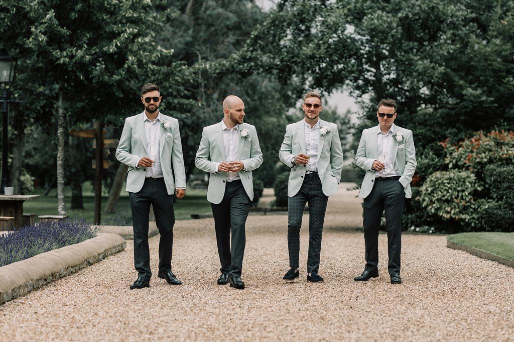 Vinnie with his groomsmen prior to the ceremony in the courtyard at The Tythe Barn in Launton - photo by The Kensington Photographer