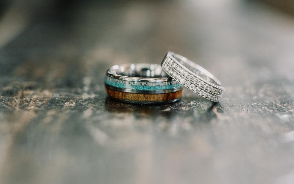 A close up of Erin and Vinnie's chosen wedding rings with beautiful detail - photo by The Kensington Photographer