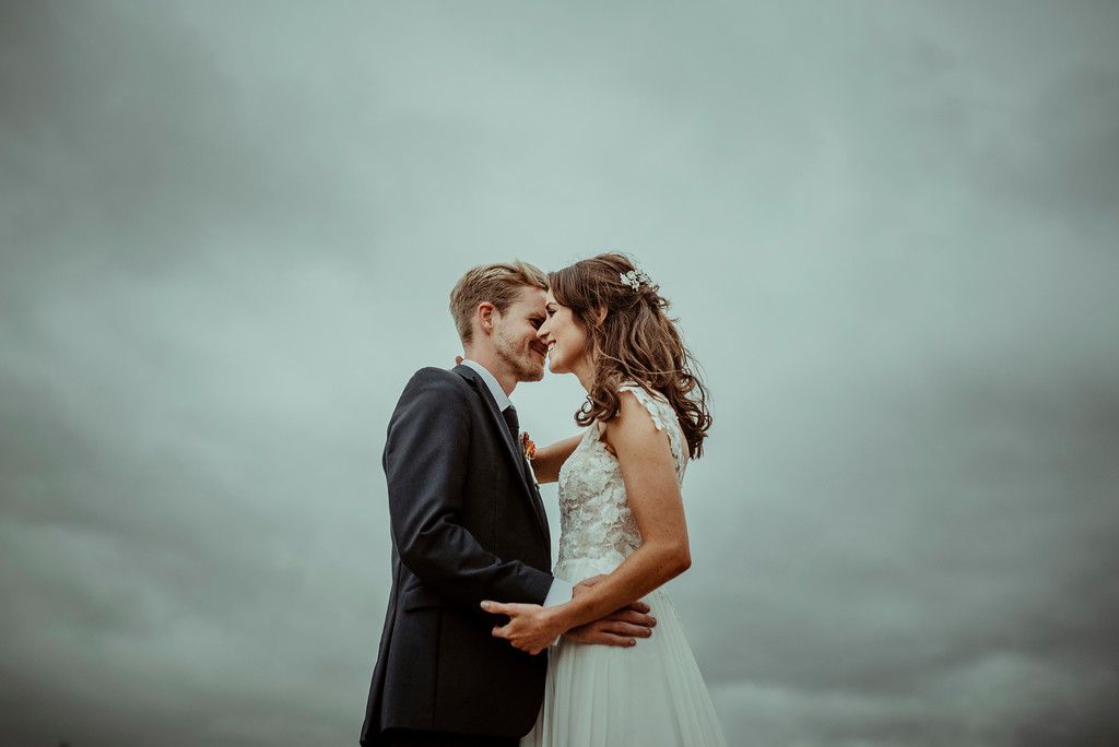 Jenny and Charlie Caribbean themed wedding - couples portrait moody sky - photography by Jess Soper Photogaphy, videography by Veiled Productions