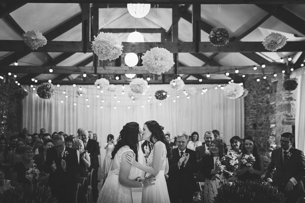 Kay and Rach first kiss as newlyweds. Sophisticated Barn Wedding. Photography by Tiree Dawson Photography. Videography by Veiled Productions. Sophisticated New House Farm wedding in the Summer 2019.