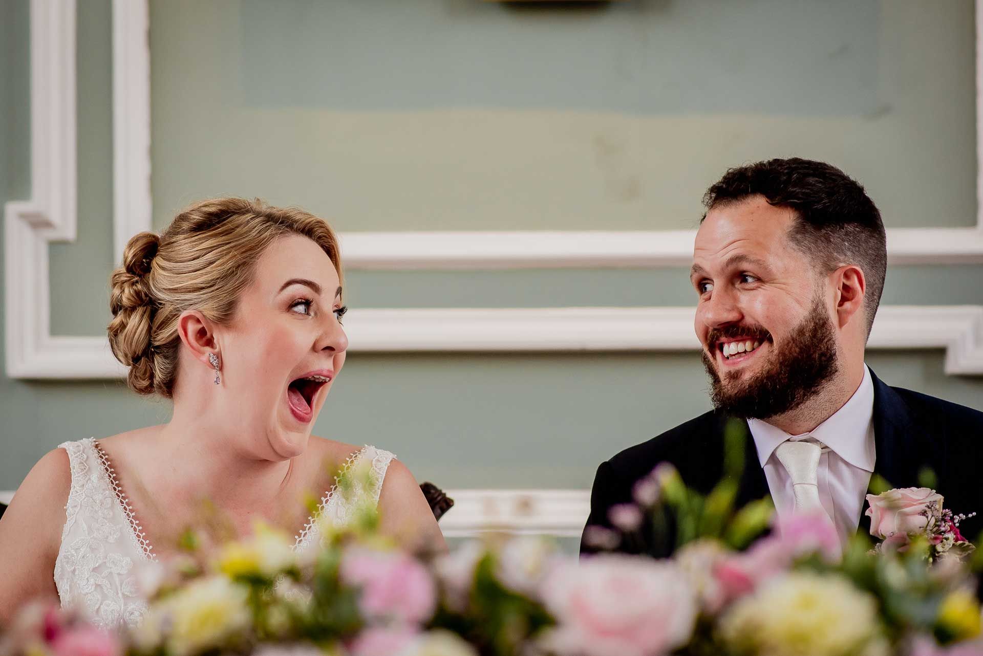 Leah and Nic looking at each exclaiming with their mouths open as if to say 'oh my we are married'. Photo thanks to Damien Vickers Photography.