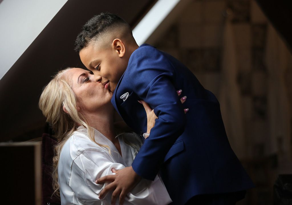 Bride getting ready for wedding sharing a hug with her son before the ceremony - unique wedding preparation photos - Photography by Wrapp Weddings - Videography by Veiled Productions - The Barns at Redcoats wedding videographer