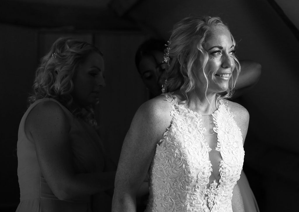 Bride Leanne with her bridesmaids getting ready in the honeymoon suite at The Barns at Redcoats Bride - Photography by Wrapp Weddings - Videography by Veiled Productions - The Barns at Redcoats wedding videographer