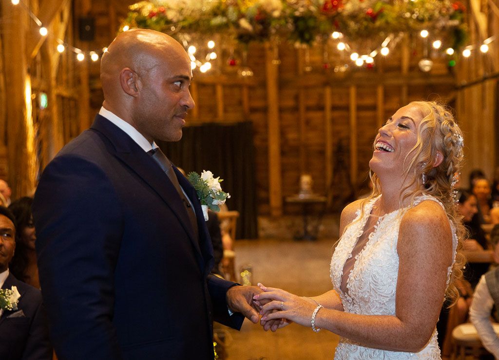 Bride and groom sharing a funny moment during their civil wedding ceremony - Photography by Wrapp Weddings - Videography by Veiled Productions - The Barns at Redcoats wedding videographer