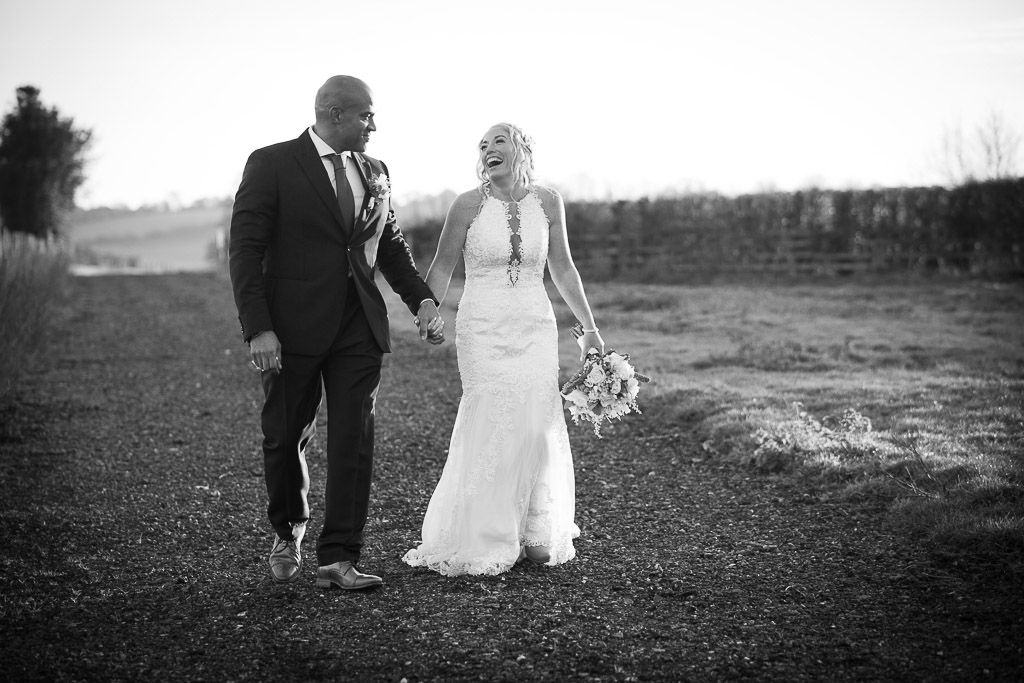 Happy couple taking a walk on their wedding day at The Farmhouse at Redcoats - Photography by Wrapp Weddings - Videography by Veiled Productions - The Barns at Redcoats wedding videographer