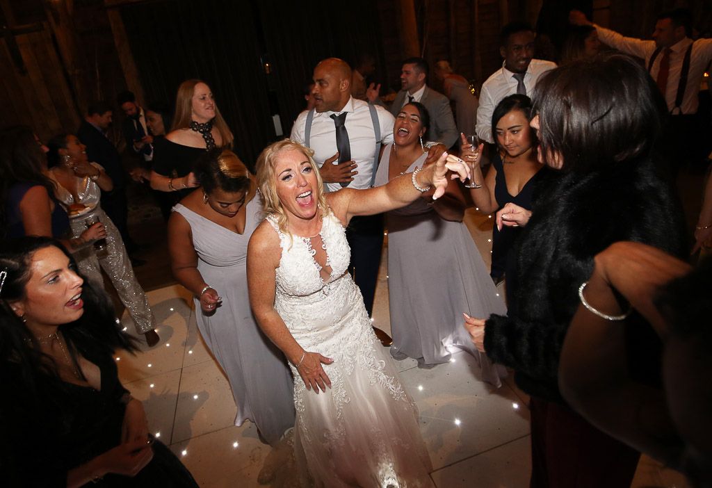 Bride Leanne partying on the dancefloor - Photography by Wrapp Weddings - Videography by Veiled Productions - The Barns at Redcoats wedding videographer