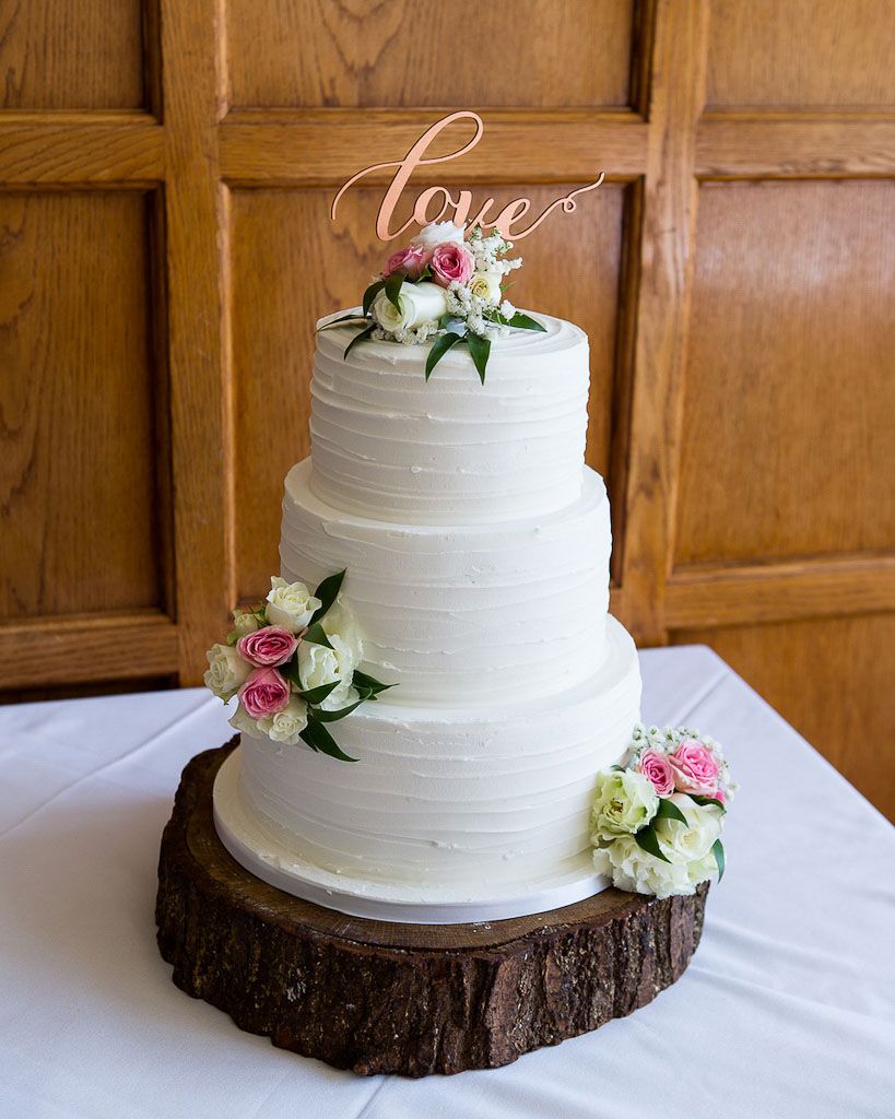 Simple and elegant 3 tier wedding cake with real flower decorations - Rebecca and Mark wedding photography by Rob Wheal Photography | Oxfordshire wedding videography by Veiled Productions