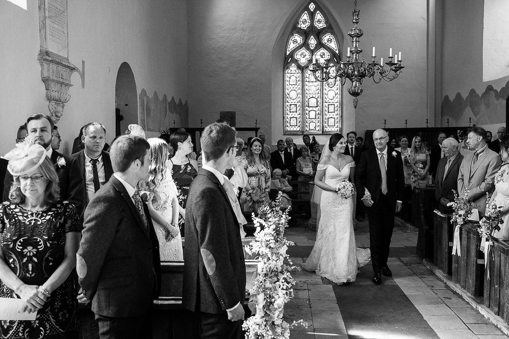 Rebecca walking down the aisle with her Dad - photography by Rob Wheal Photography | Oxfordshire wedding videography by Veiled Productions