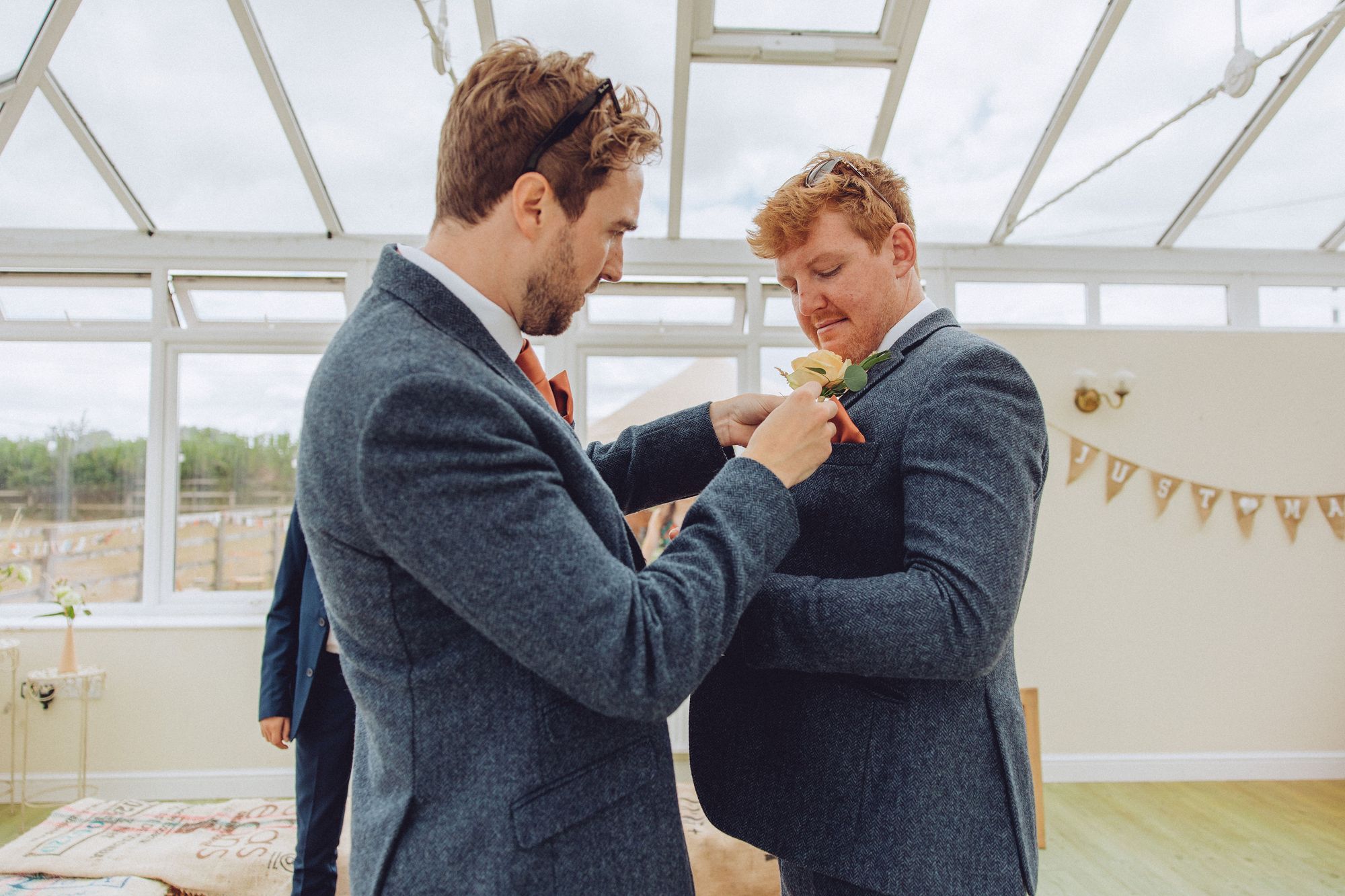 Dan having his rose button hole fitted to his suit jacket by his best man. Photo thanks to Fordtography.