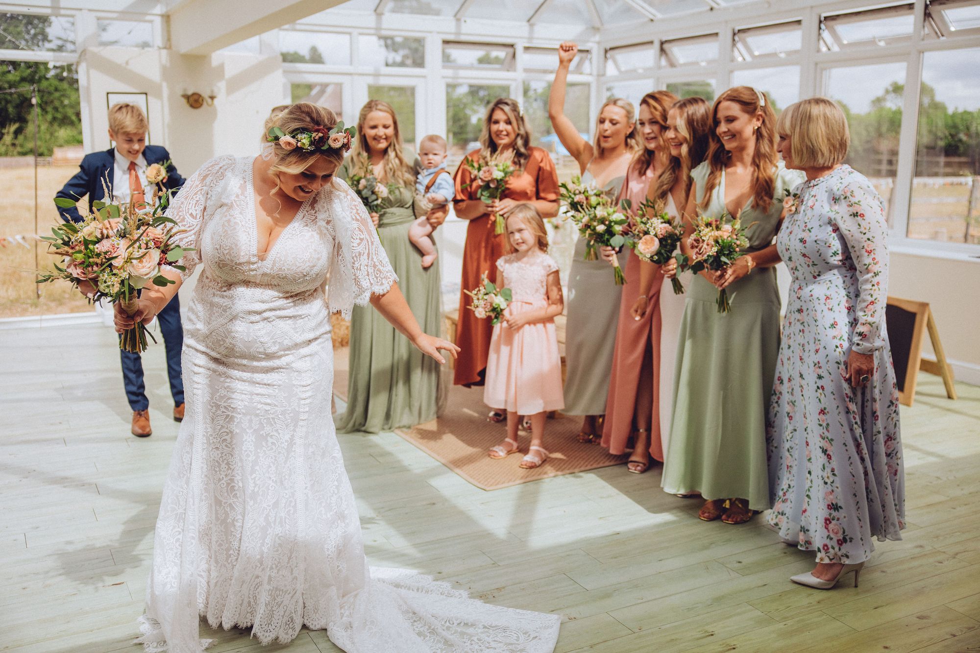 Nor revealing her lace wedding dress to her bridal party in the farm conservatory prior to the ceremony. Photo thanks to Fordtography.