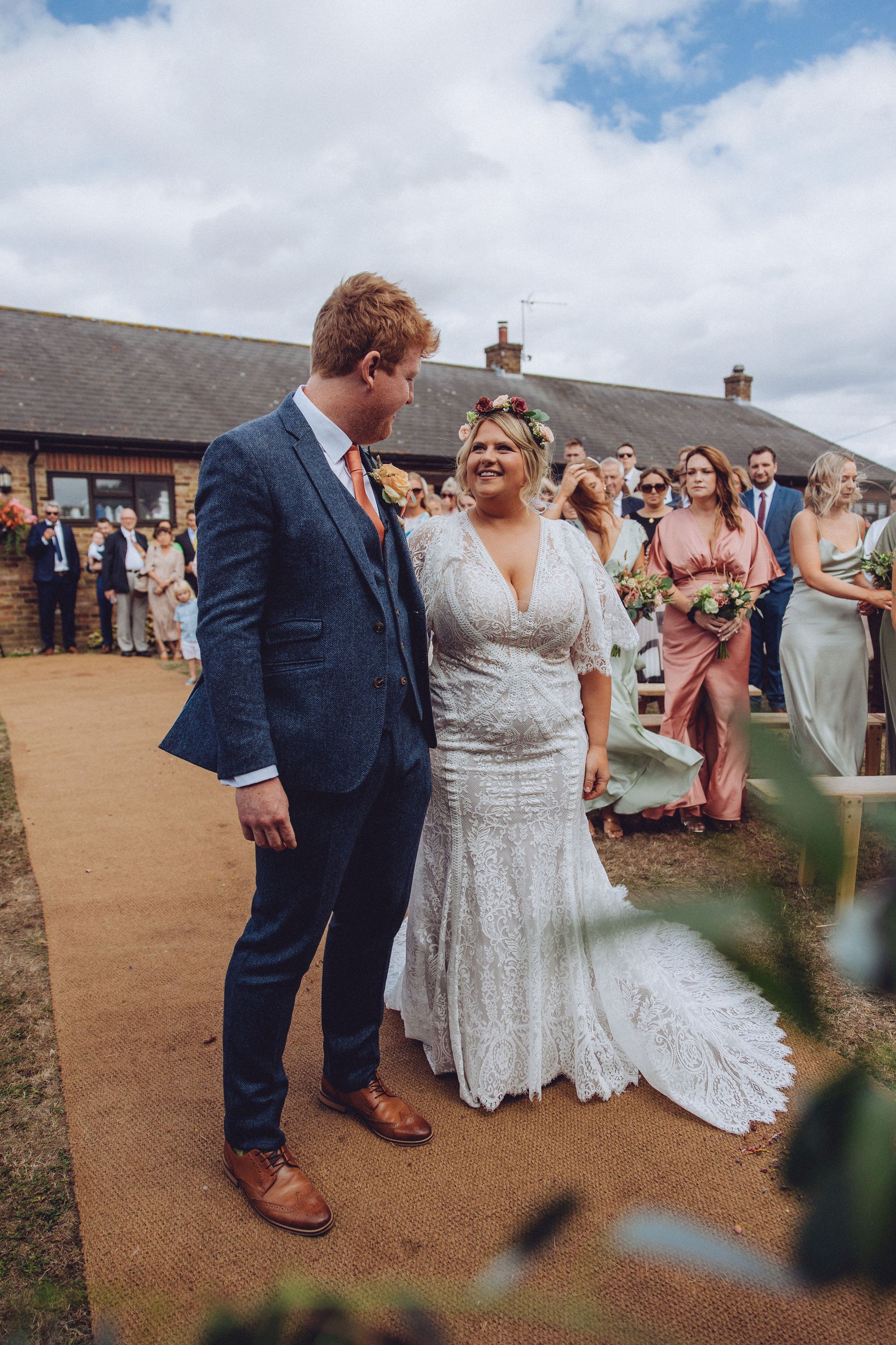 Dan and Nor meet each other at the top of the aisle at the beginning of their celebrant led wedding ceremony in the farm gardens. Photo thanks to Fordtography.