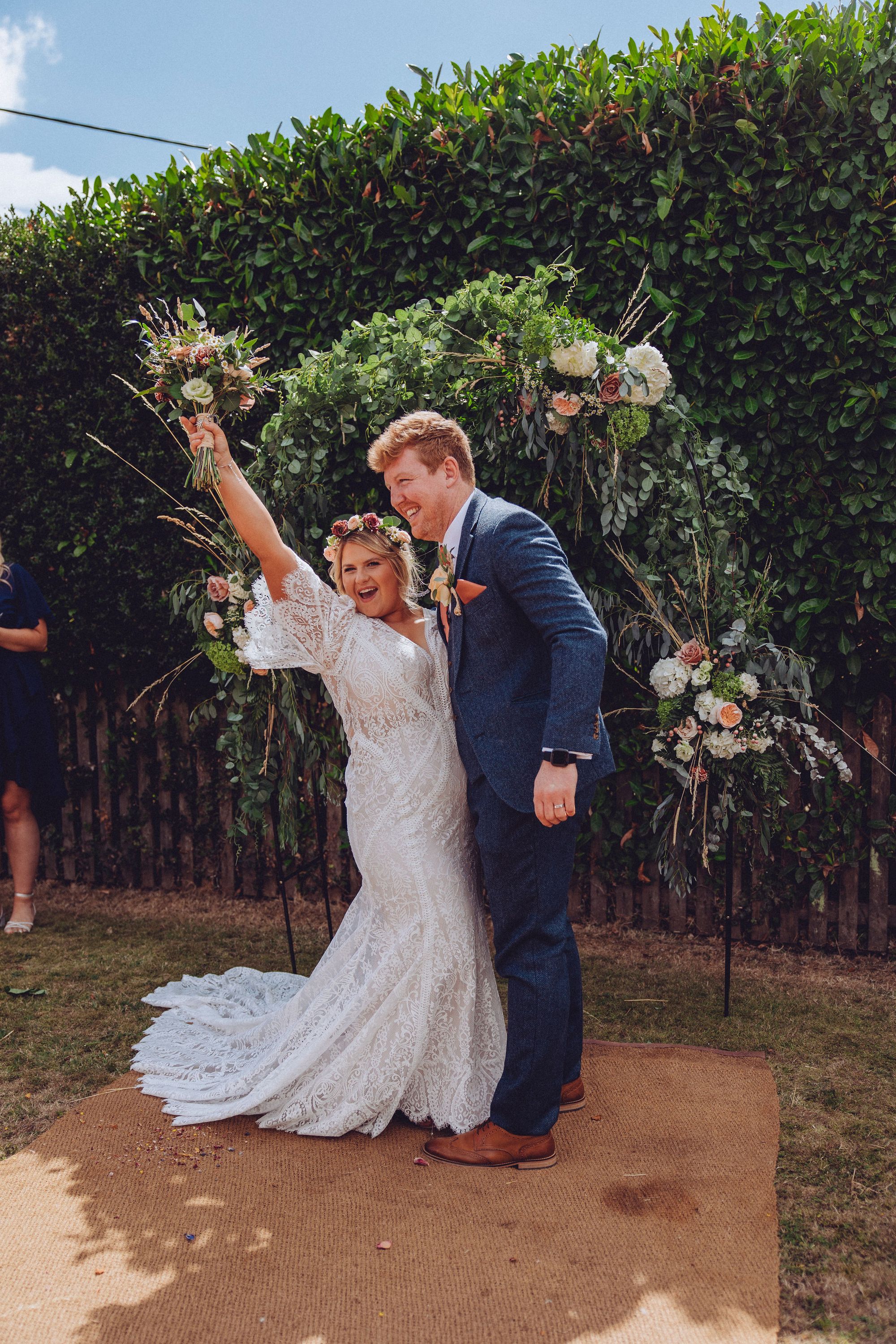 Just married! Nor and Dan celebrate - Nor cheers with her bouquet in her hand. Photo thanks to Fordtography.