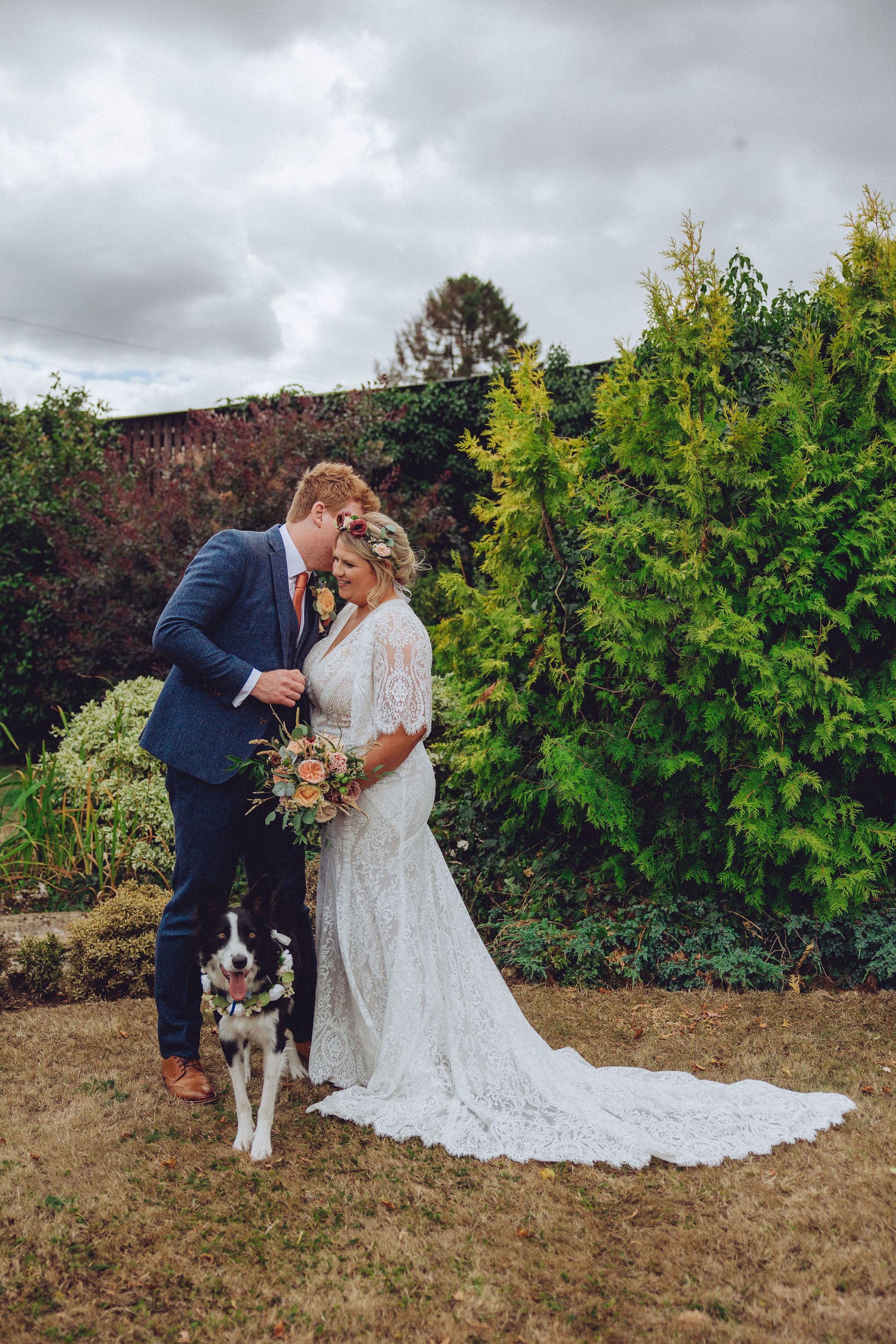 Nor and Dan with their border collie during their wedding reception in the farm gardens. Photo thanks to Fordtography.