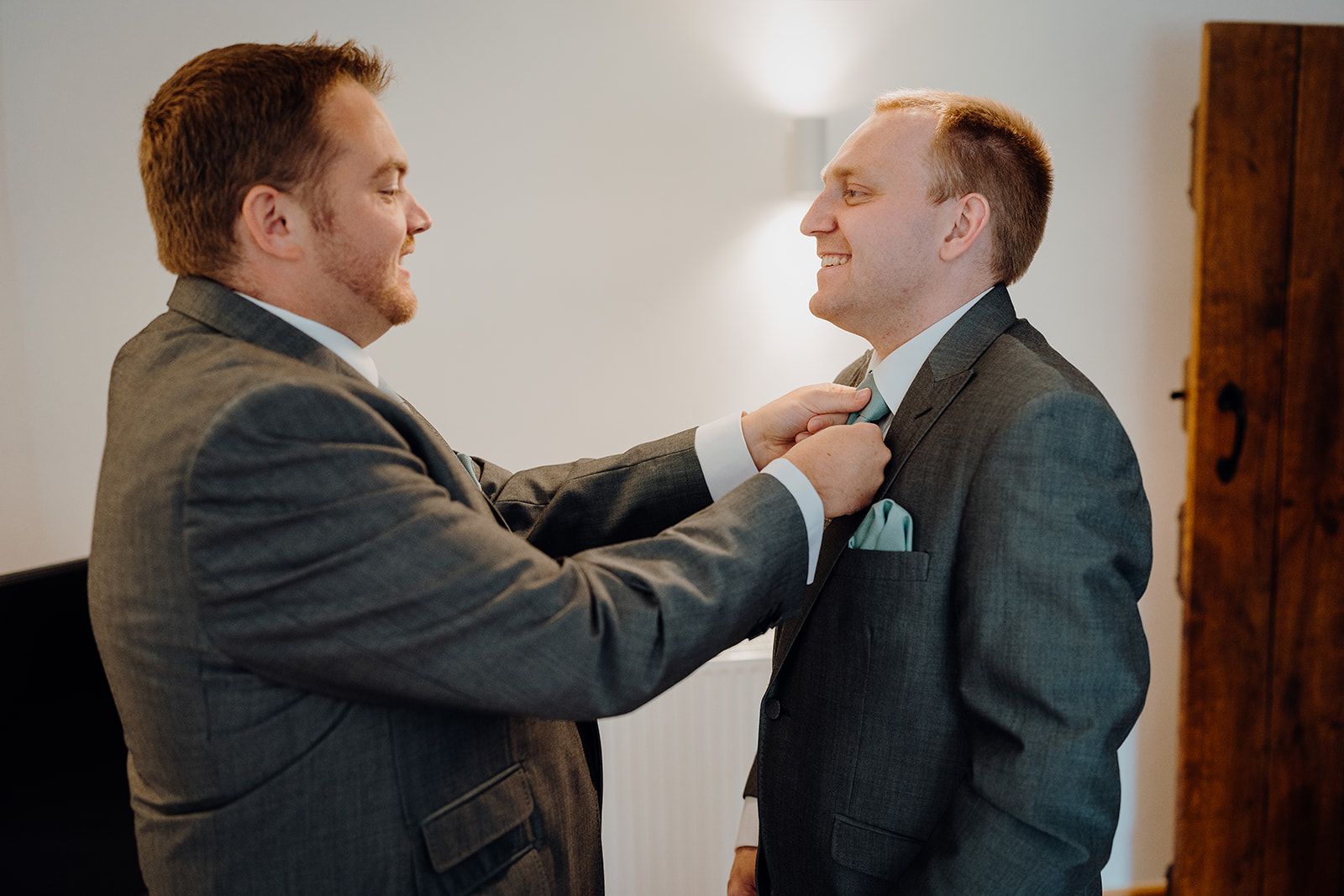 James having his tie adjusted by his best man on the morning of his wedding at Huntsmill Farm. Photo thanks to Sam and Steve Photography.