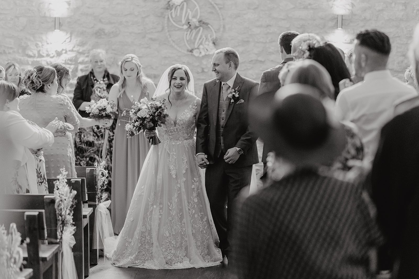 Georgie and James exiting their wedding ceremony as newlyweds. Photo thanks to Sam and Steve Photography. 