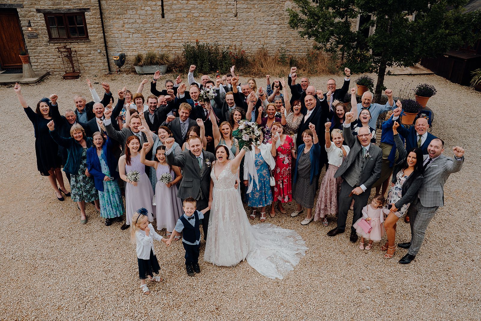 A photo of all Georgie and James' guests cheering! Taken by Sam and Steve Photography.