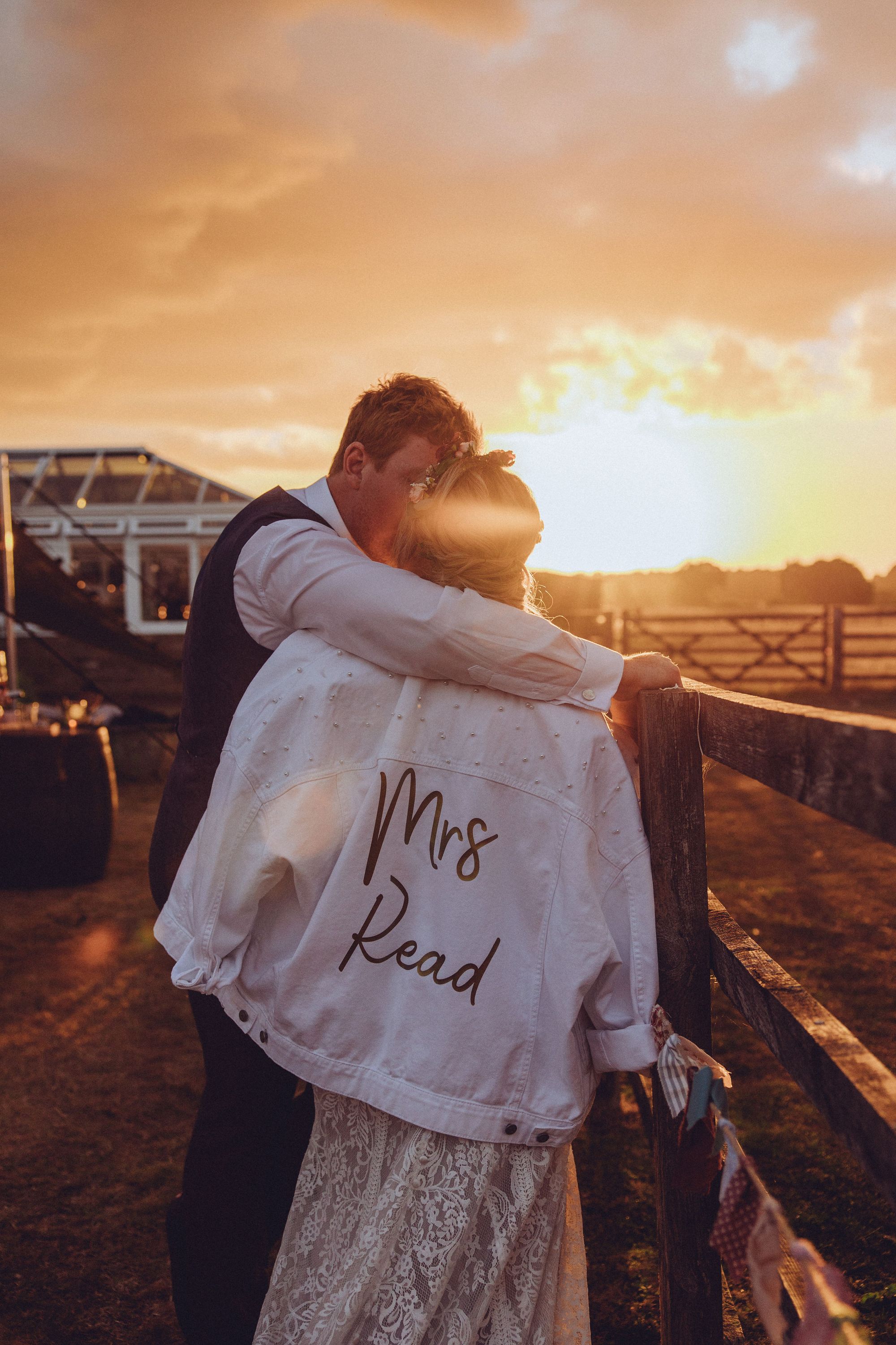 Gorgeous sunset wedding photo with bride Nor wearing her personalised white denim jacket. Photo thanks to Fordtography.