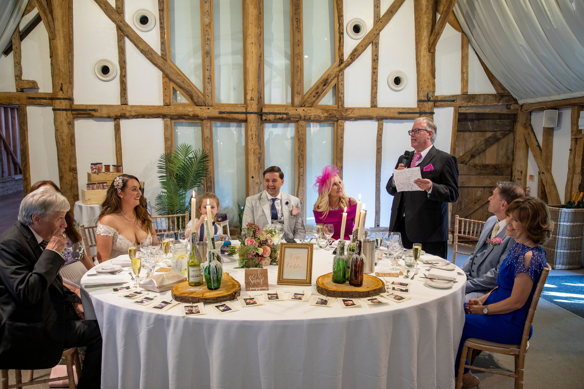 The top table during Joanna and Rafal's toasts in the barn at South Farm. Lots of smiles with beautiful candle decorations. Photo thanks to Nigel Charman Photography.