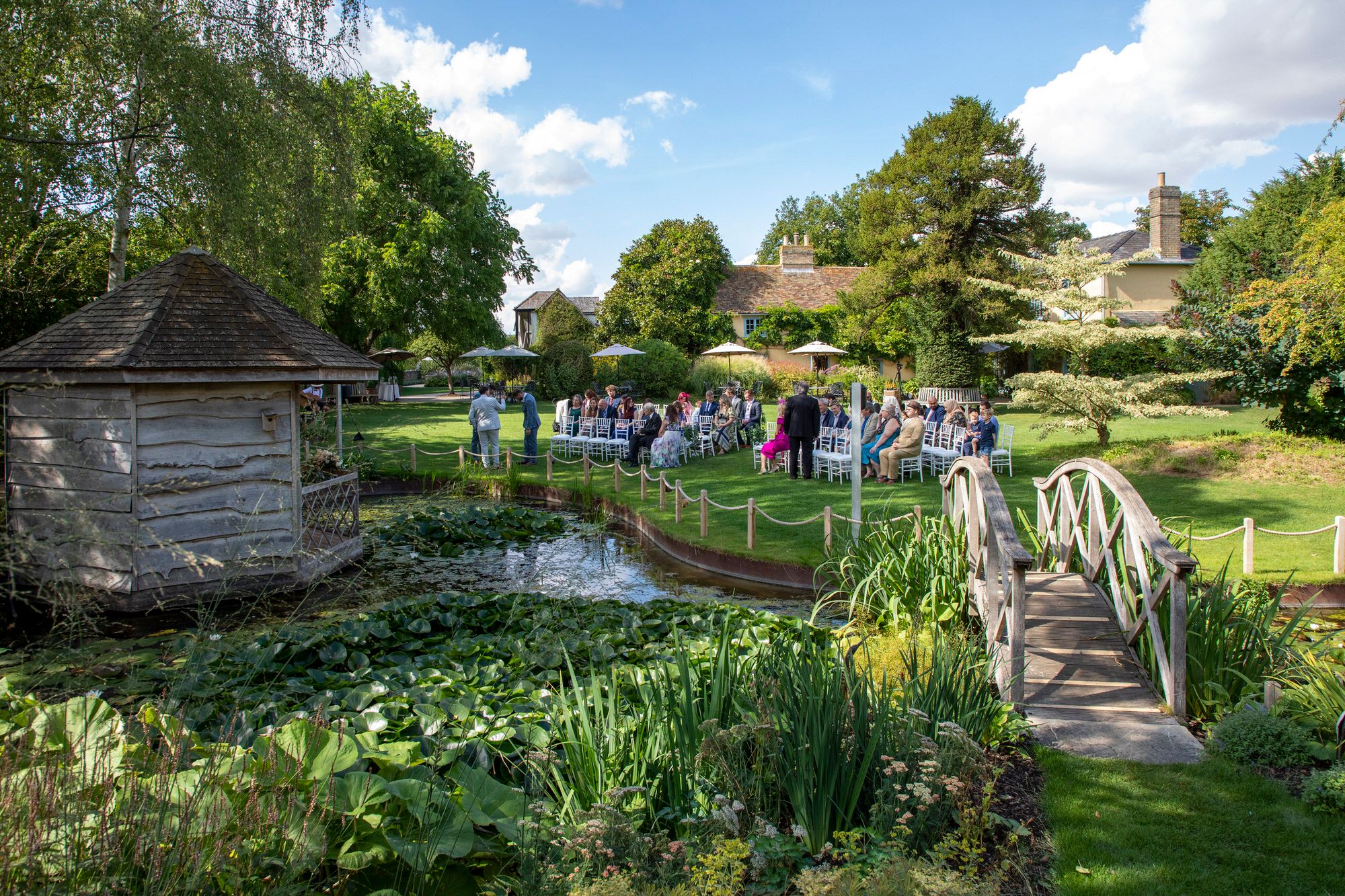 Wide angle photo of the Summer House and all of Joanna and Rafal's wedding guests prior to the civil ceremony at South Farm. Photo thanks to Nigel Charman Photography. 