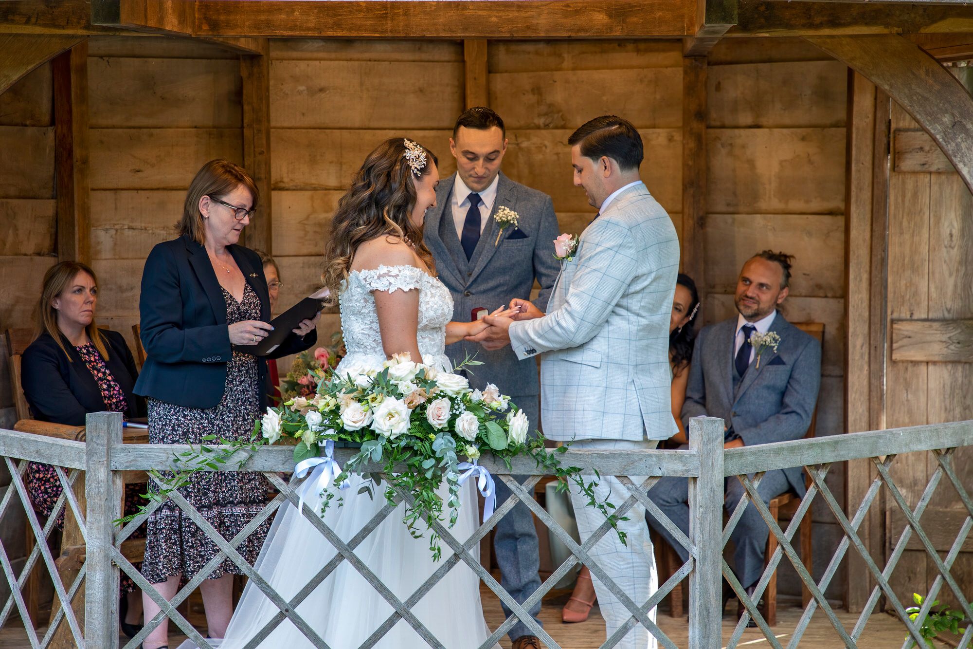 Joanna and Rafal exchanging wedding rings in the Summer House at South Farm in Cambridgeshire. Photo thanks to Nigel Charman Photography.
