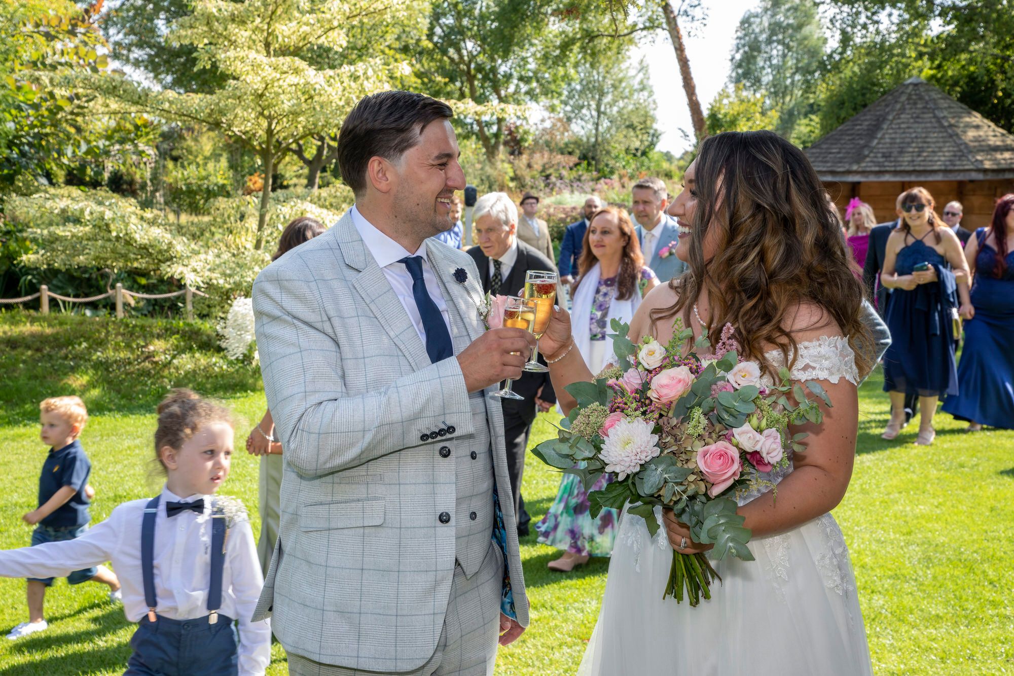 Newlyweds toasting their marriage with a drink after their wedding ceremony in the Summer House at South Farm in Cambridgeshire. Photo thanks to Nigel Charman Photography. 