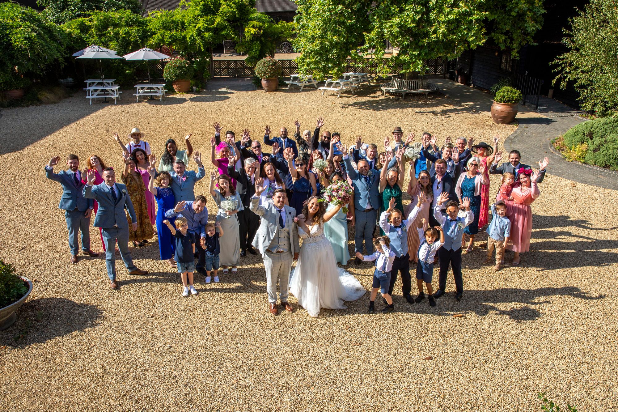Photo of all Joanna and Rafal's wedding guests taken from the first floor of the farmhouse, over looking the courtyard at South Farm in Cambridgeshire. Photo thanks to Nigel Charman Photography. 