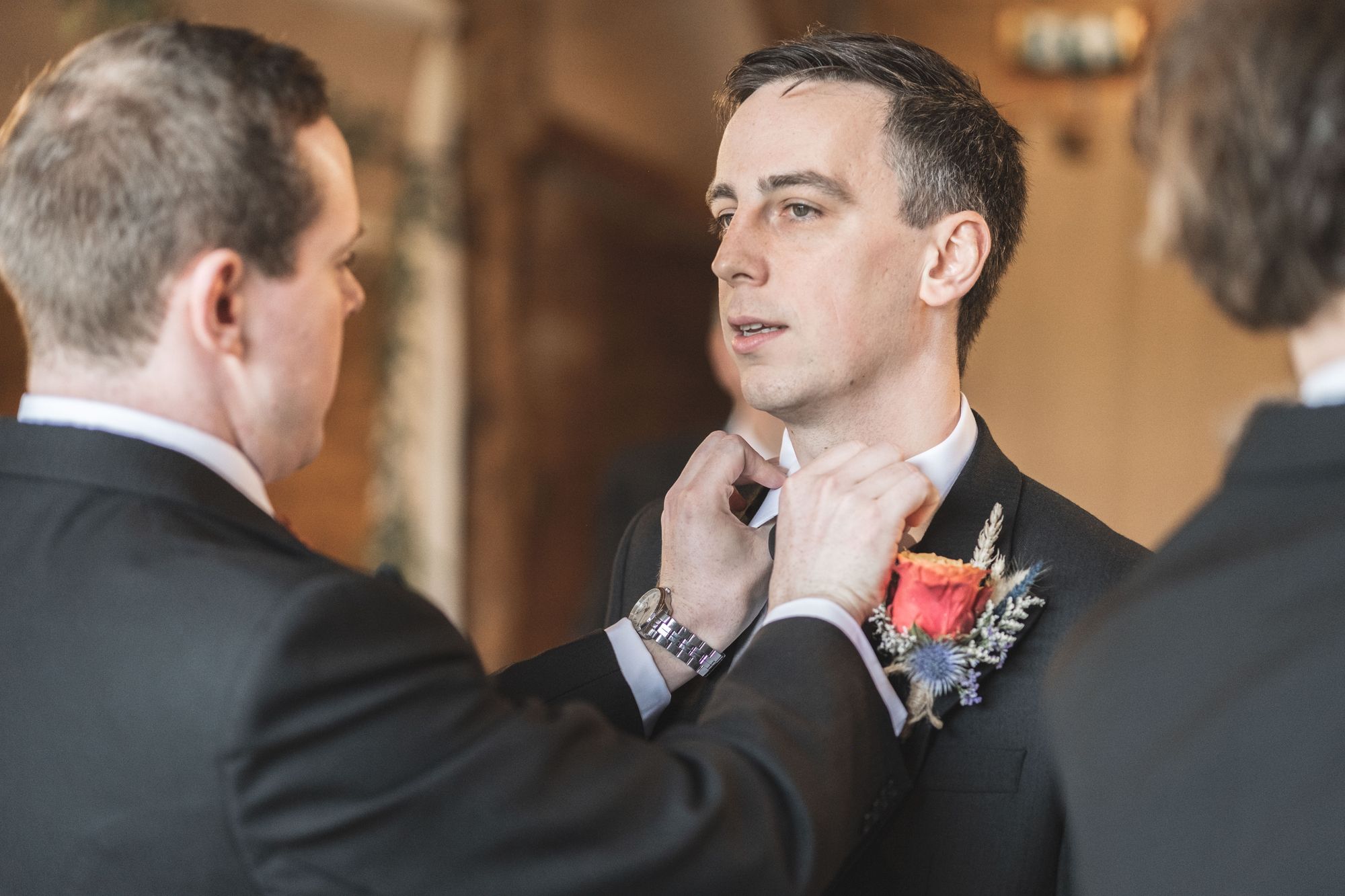 James' best man adjusting James' tie and collar prior to the wedding ceremony at Lains Barn. Photo thanks to The Falkenburgs via Big Day Productions