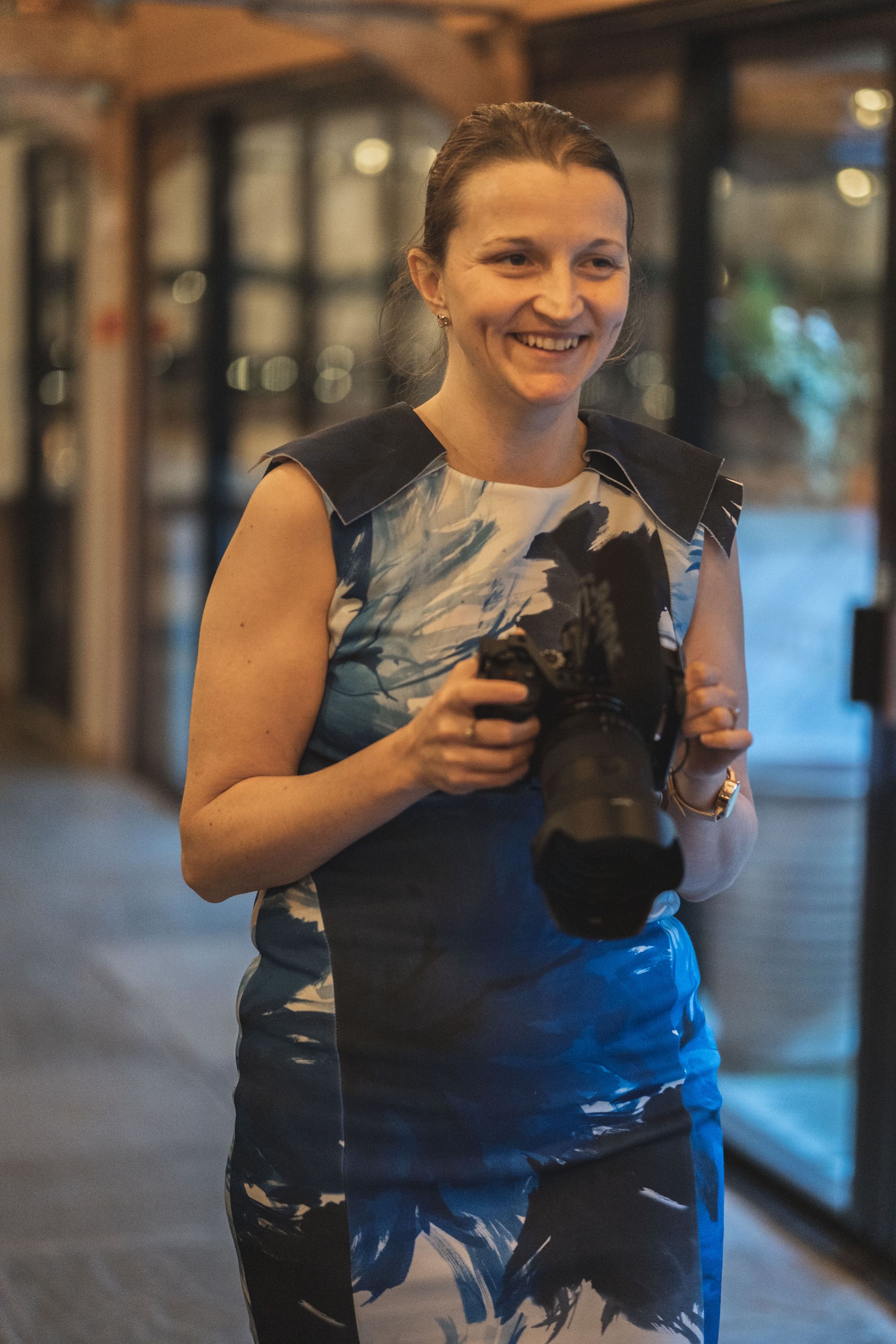 Rachel from Veiled Productions smiling holding her video camera. Photo thanks to The Falkenburgs via Big Day Productions.