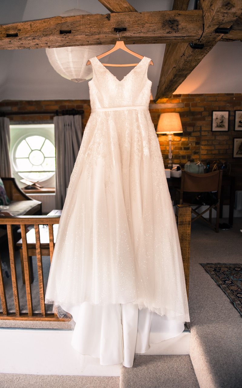 Kelly's gorgeous wedding dress hanging from the beam in the honeymoon suite at Wasing Park. Photo thanks to Zoe Warboys Photography.