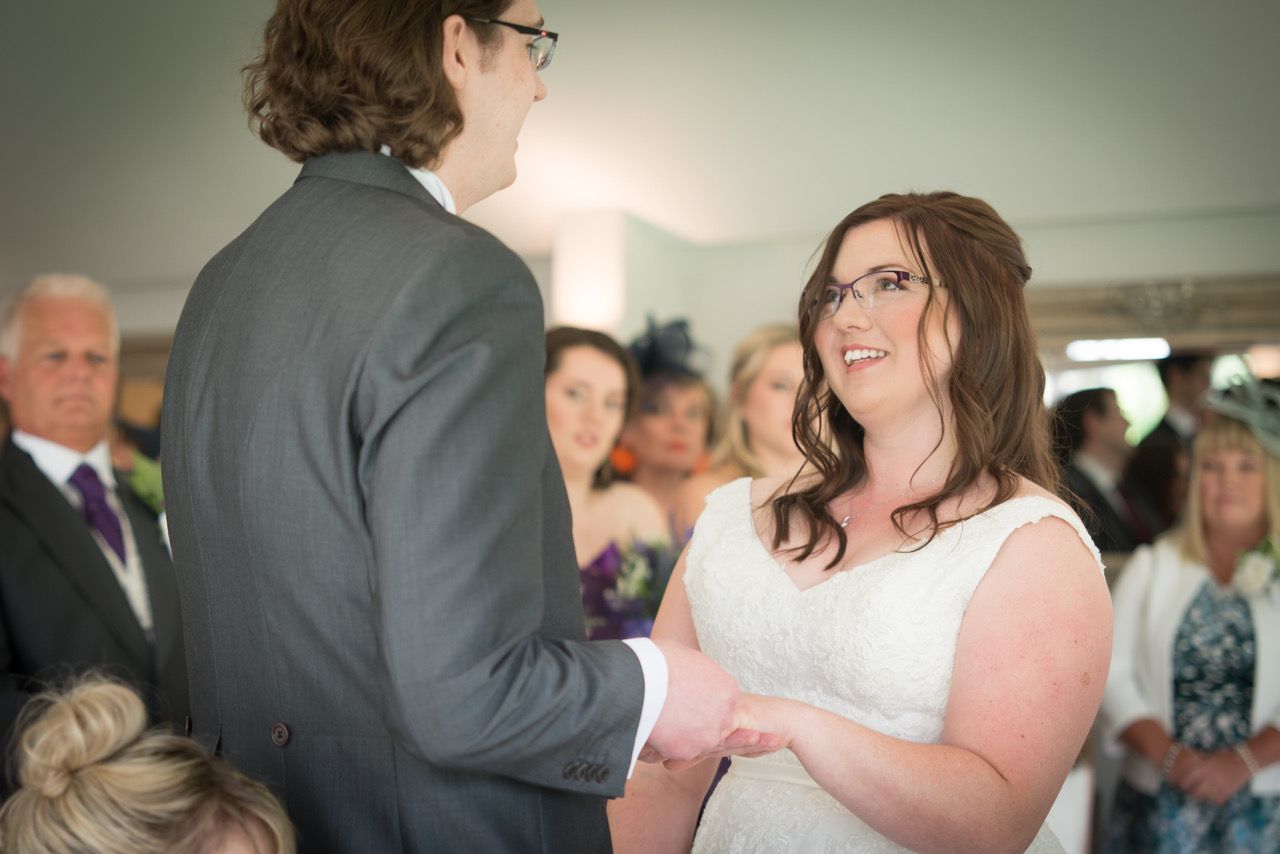 Kelly and Finn exchange wedding rings during their civil wedding ceremony in The Garden Room at Wasing Park. Photo thanks to Zoe Warboys Photography.