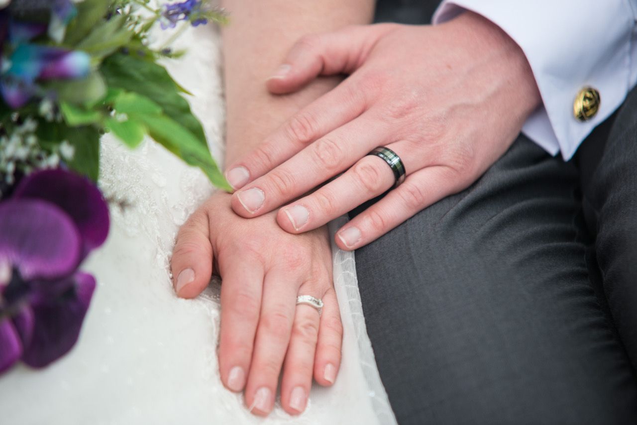 A close up photo of Kelly and Finn's hands with their new wedding rings. Photo thanks to Zoe Warboys Photography at Wasing Park.