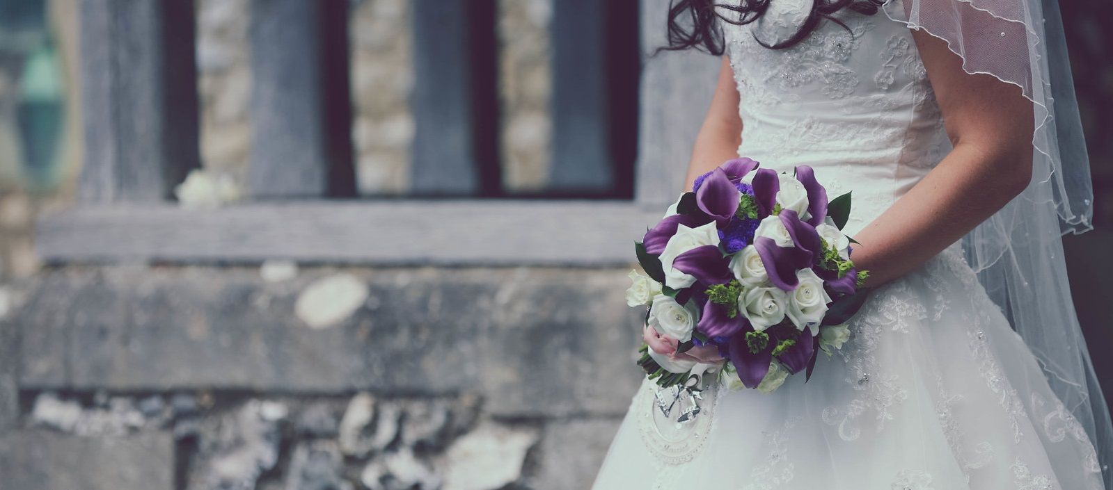A bride holds a beatiful bouquet at a church wedding in Oxfordshire