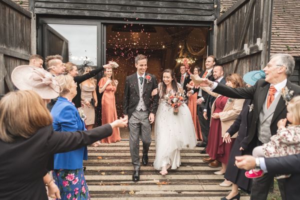 James and Jennifer exiting Lains Barn as their guests throw confetti! Photo thanks to The Falkenburgs
