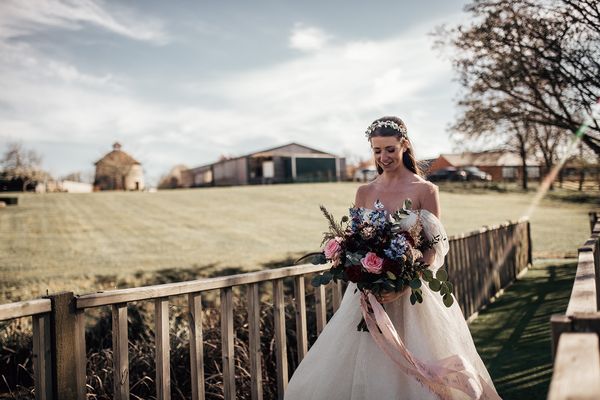 Bride walking across the bridge to the gazebo at Furtho Manor Farm.